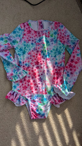 none 5-6 years but runs a little big, LS stars w/ruffles, zip up back 6T/6X